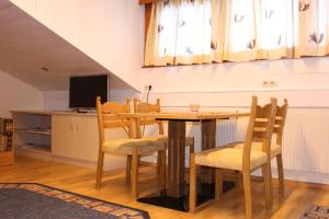 a dining room with a wooden table and chairs at Josef Pixner in Sölden