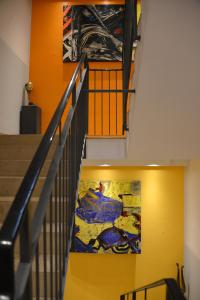 a staircase in a building with a painting on the wall at Arthotel Munich in Munich