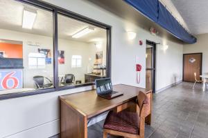 a laptop on a wooden desk in a room at Motel 6-Percival, IA in Percival