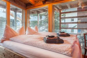 a bedroom with a bed with two teddy bears on it at Chalet Schwalbennest in Zermatt