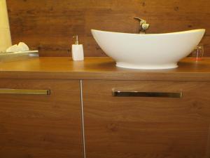 a bowl sink on top of a wooden counter at Hotel Cebulj in Bad Wörishofen