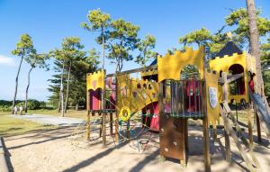 a playground in a park with a play structure at Domaine Résidentiel de Plein Air Odalys Tamarins Plage in Le Bois-Plage-en-Ré