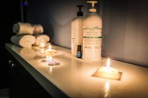 a bathroom counter with candles and a bottle of soap at Divčibarski Vajati in Divčibare