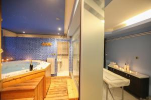 a bathroom with a large tub and a shower at Divčibarski Vajati in Divčibare