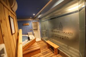 a bathroom with a tub and a wooden floor at Divčibarski Vajati in Divčibare
