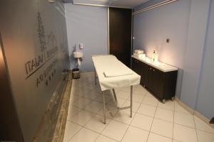a bathroom with a white table and a stool at Divčibarski Vajati in Divčibare