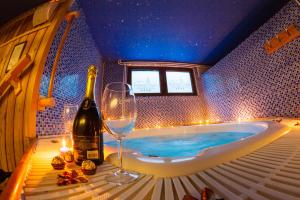 a bottle of wine and a wine glass in a tub at Divčibarski Vajati in Divčibare