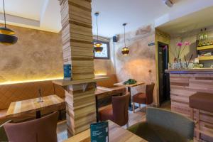 a restaurant with tables and chairs and a pillar at Divčibarski Vajati in Divčibare
