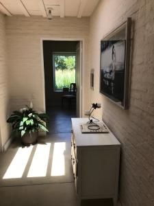 a room with a table and a tv on a wall at La Chacra Jose Ignacio in José Ignacio