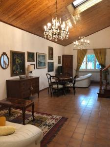 a living room with a chandelier and a table at Il portico B&b in Faenza