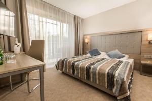 Łóżko lub łóżka w pokoju w obiekcie Villa Bravo & SPA