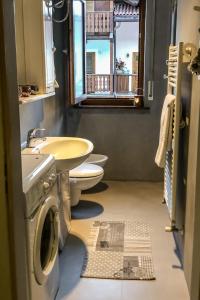 a bathroom with a sink and a washing machine at Residence Des Alpes in Canazei