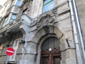 a building with a brown door and a red stop sign at Carpe Noctem Hostel in Budapest