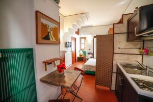 a kitchen with a table and a room with a bed at Il Carretto Taormina Center in Taormina