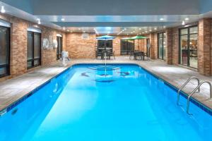 a swimming pool with blue water in a building at Comfort Inn & Suites Columbus North in Columbus