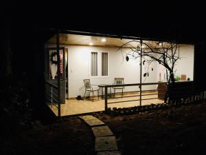 a house with a table and chairs on a porch at Farm'ily in Da Lat
