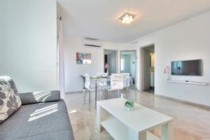a living room with a couch and a table at Apartments Antunovic in Umag