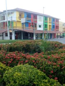 a colorful building with flowers in front of it at Pousada Pelourinho in Mucuri