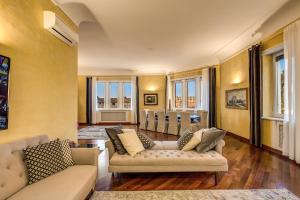 a living room with two couches and a dining room at Imperial Panorama Penthouse in Rome