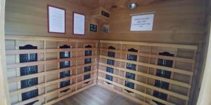 a room with wooden walls and racks of books at kinneret love sounds in Migdal
