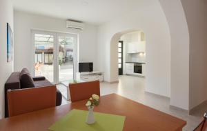 a living room with a couch and a table at Villa Podgorka in Podgora