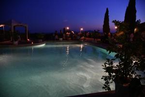 a large swimming pool at night at Podere Santa Maria in Monte Antico