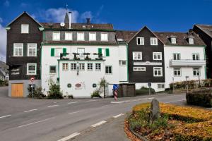 un bâtiment blanc sur le côté d'une rue dans l'établissement Hotel Reinhold, à Gummersbach