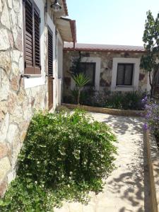 a house with some bushes in front of a building at Villa Lucia in Lampedusa