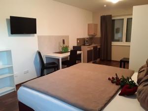 a room with a bed and a table with a desk at Erlachmühle in Mondsee
