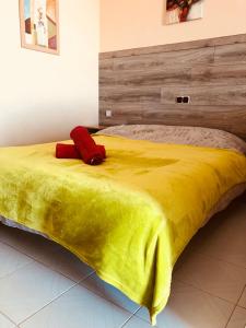 a bed with a yellow blanket on top of it at Atlantic Ocean View in Adeje