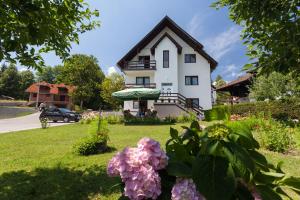 a house with flowers in front of it at Vila Slavica in Zlatibor