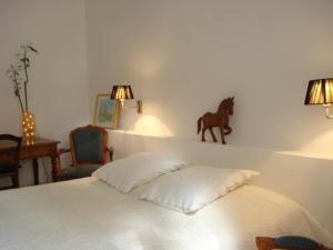 a bedroom with a bed with a statue of a horse on the wall at Lou Ventoulet in Mouriès