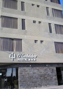 a building with a sign on the side of it at Hostal El Candelabro in Pisco