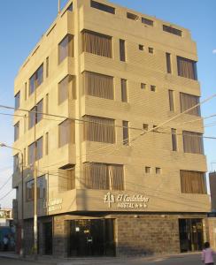 a tall building on the corner of a street at Hostal El Candelabro in Pisco