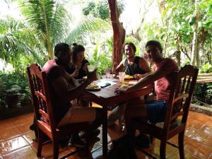 a group of people sitting around a table at Hostal La Gloria in Mérida