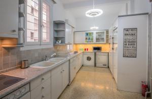 a kitchen with two sinks and a dishwasher at Capricorn - Luxurious apartment in Kolonaki in Athens