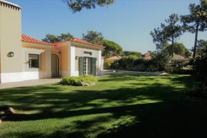 a house with a large yard with green grass at Luxury Private Villa with Pool - Cascais in Cascais
