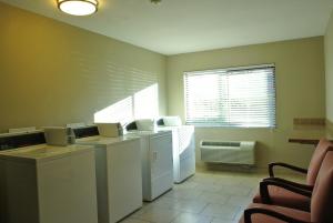 a laundry room with a washer and dryer and a window at Best Western Seattle Airport Hotel in SeaTac
