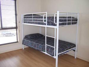 a room with three bunk beds in a room at Relax On Par in Port Hughes