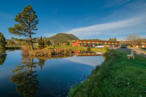 a building with a lake in front of a building at Discovery Lodge in Estes Park