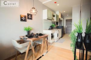a kitchen and dining room with a table and chairs at The Astra Condo Chiang Mai - A624 in Chiang Mai