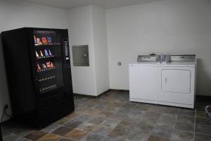 a kitchen with a black refrigerator and a stove at Wine Country Inn in Fredericksburg