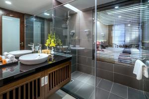 a bathroom with a sink and a glass shower at Amazing Hotel Sapa in Sapa