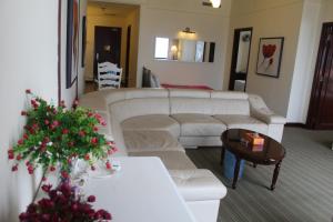 a living room with a white couch and a table at Best Apartment at Times Square in Kuala Lumpur