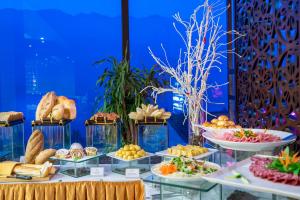 a buffet of bread and pastries on display at Amazing Hotel Sapa in Sapa