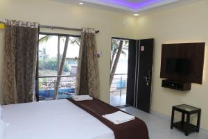 Posteľ alebo postele v izbe v ubytovaní Sunshine Homestay Malvan