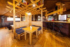 a restaurant with a table and chairs and a bar at Tsentr Otdykha Da-Shi in Sarma