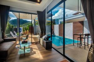 a living room with a view of a swimming pool at KG Private Pool Villa in Ao Nang Beach