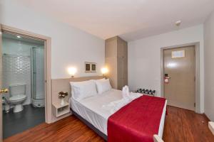 a bedroom with a large bed and a bathroom at Febor Park İstanbul Levent Hotel in Istanbul