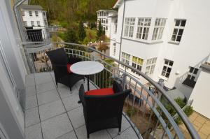 a balcony with a table and chairs on it at Villa Rosa - Apt. 10 in Ostseebad Sellin